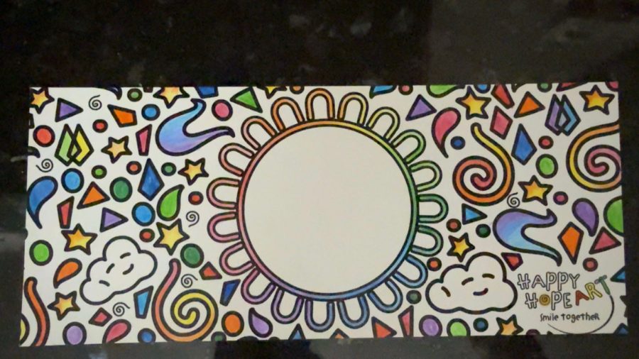 A second card with the sun outline traced in rainbow marker and the Happy Hope Art mark in the corner
